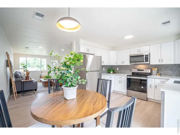 a kitchen with a table and chairs