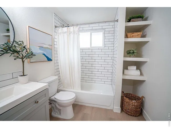 a bathroom with a toilet a sink and a shower