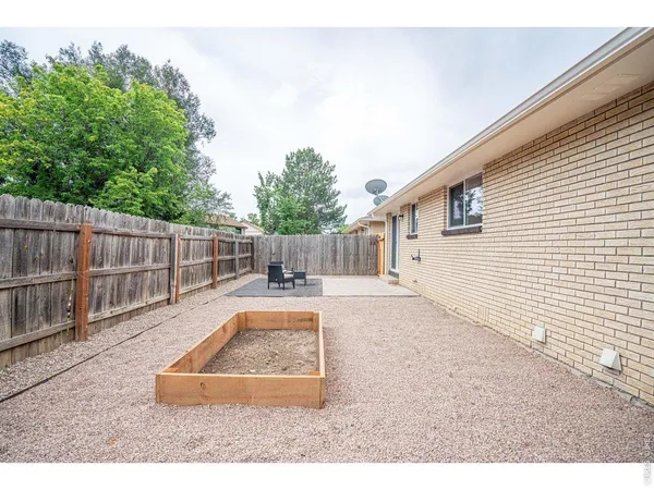 a backyard of a house with table and chairs