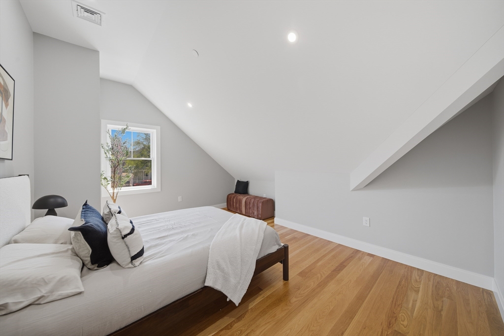 174 Walnut Street, Unit 3 Somerville, MA 02145 - Photo 18 of 38 a bedroom with a bed and wooden floor