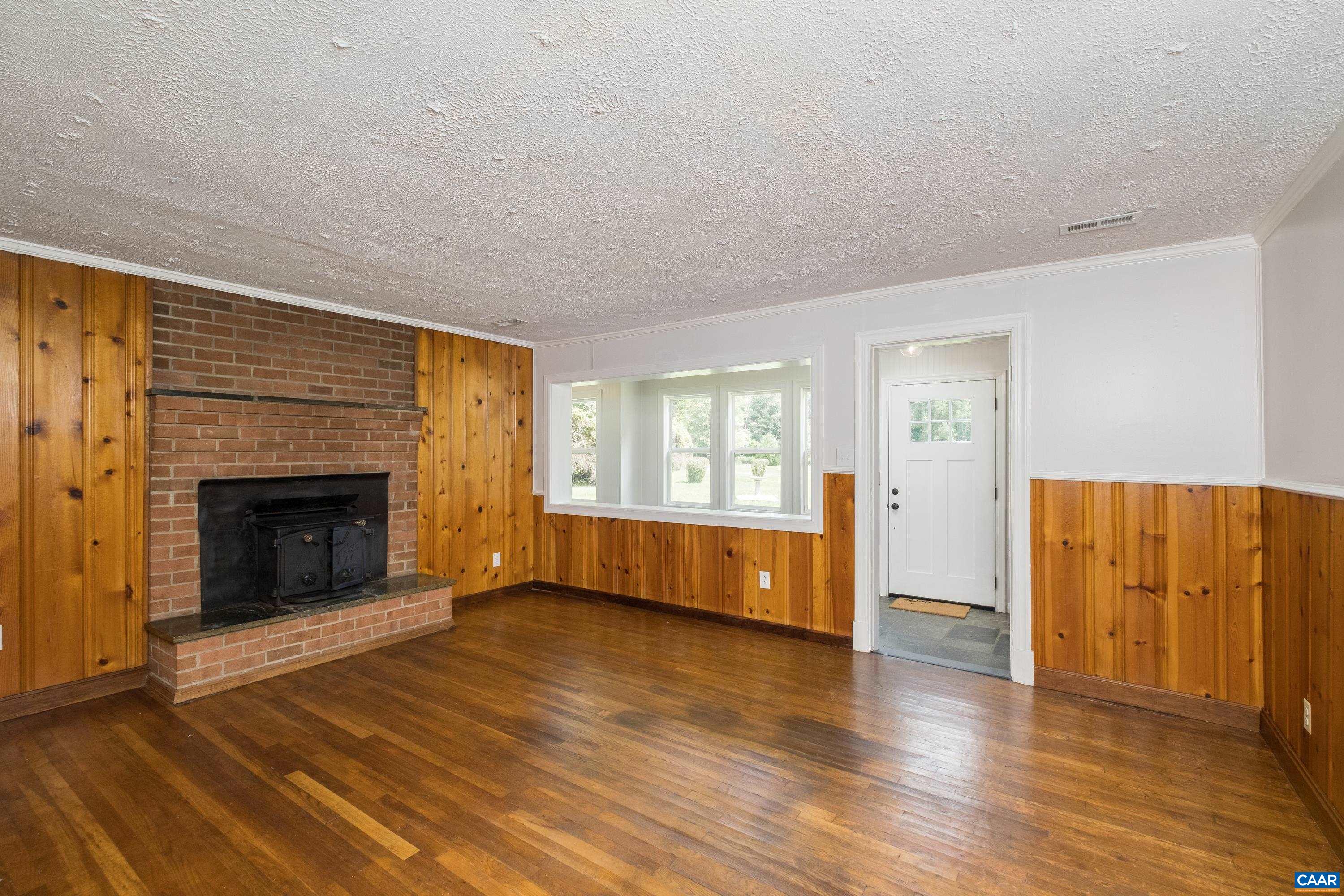 578 Maxfield Road Keswick, VA 22947 - Photo 13 of 39 a view of an empty room with window and fire place