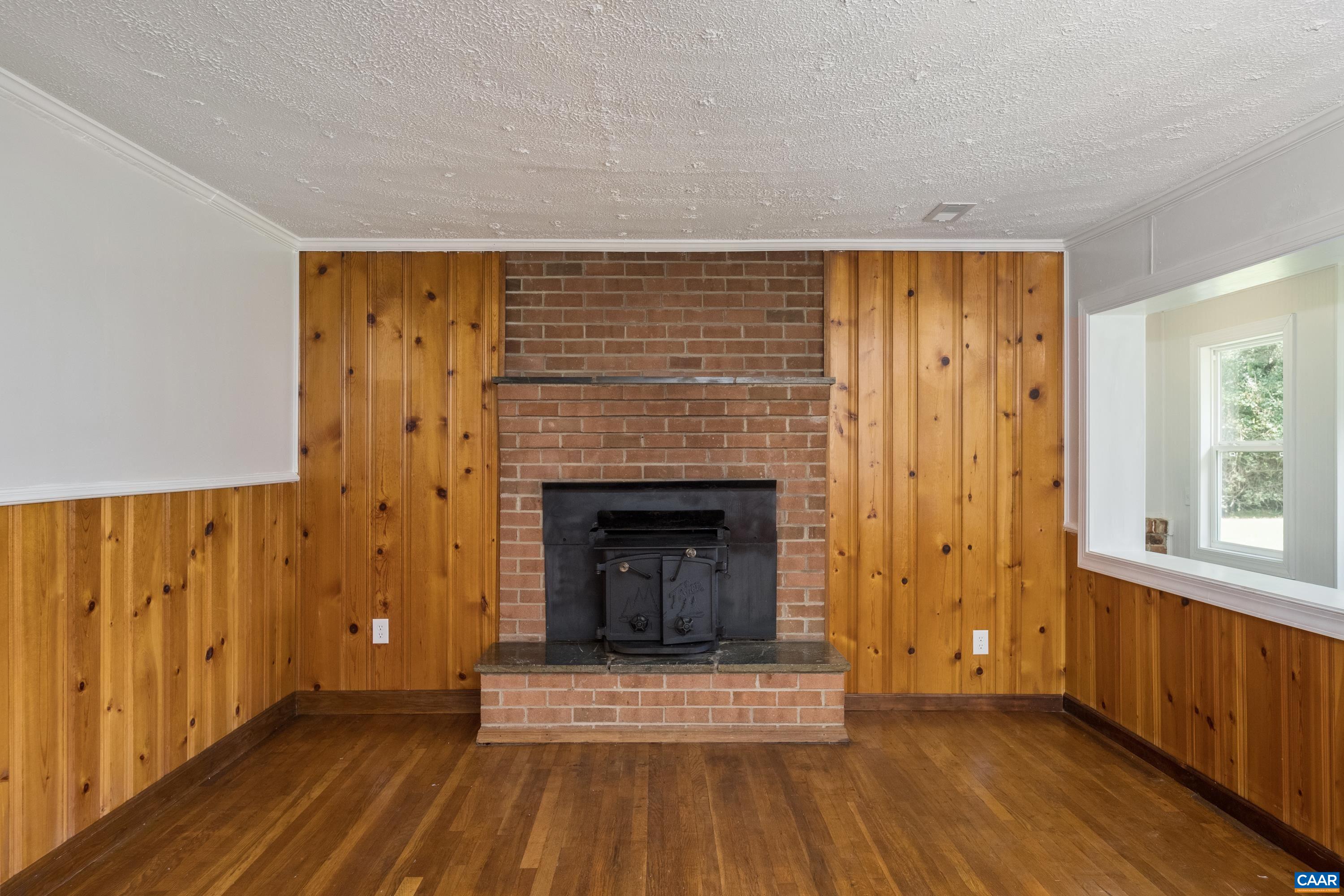 578 Maxfield Road Keswick, VA 22947 - Photo 14 of 39 a view of a livingroom with wooden floor and a fireplace