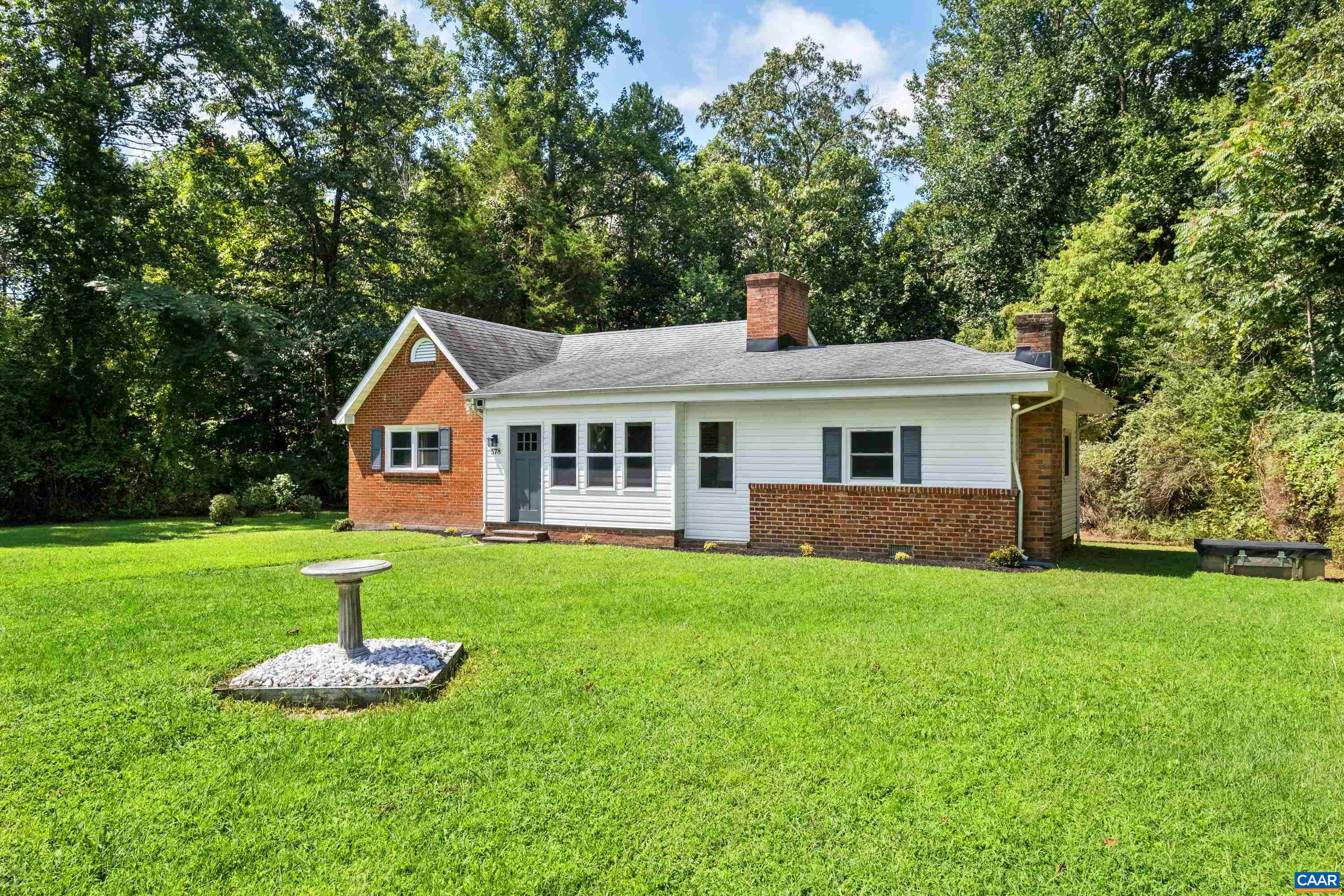 578 Maxfield Road Keswick, VA 22947 - Photo 2 of 39 a front view of a house with a yard and green space