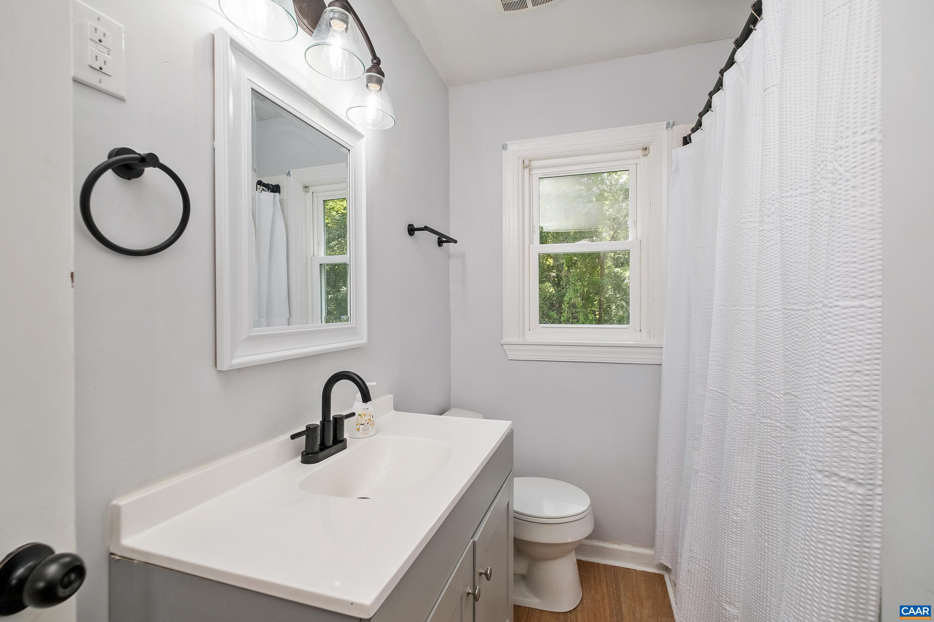 578 Maxfield Road Keswick, VA 22947 - Photo 21 of 39 a bathroom with a toilet a sink and mirror