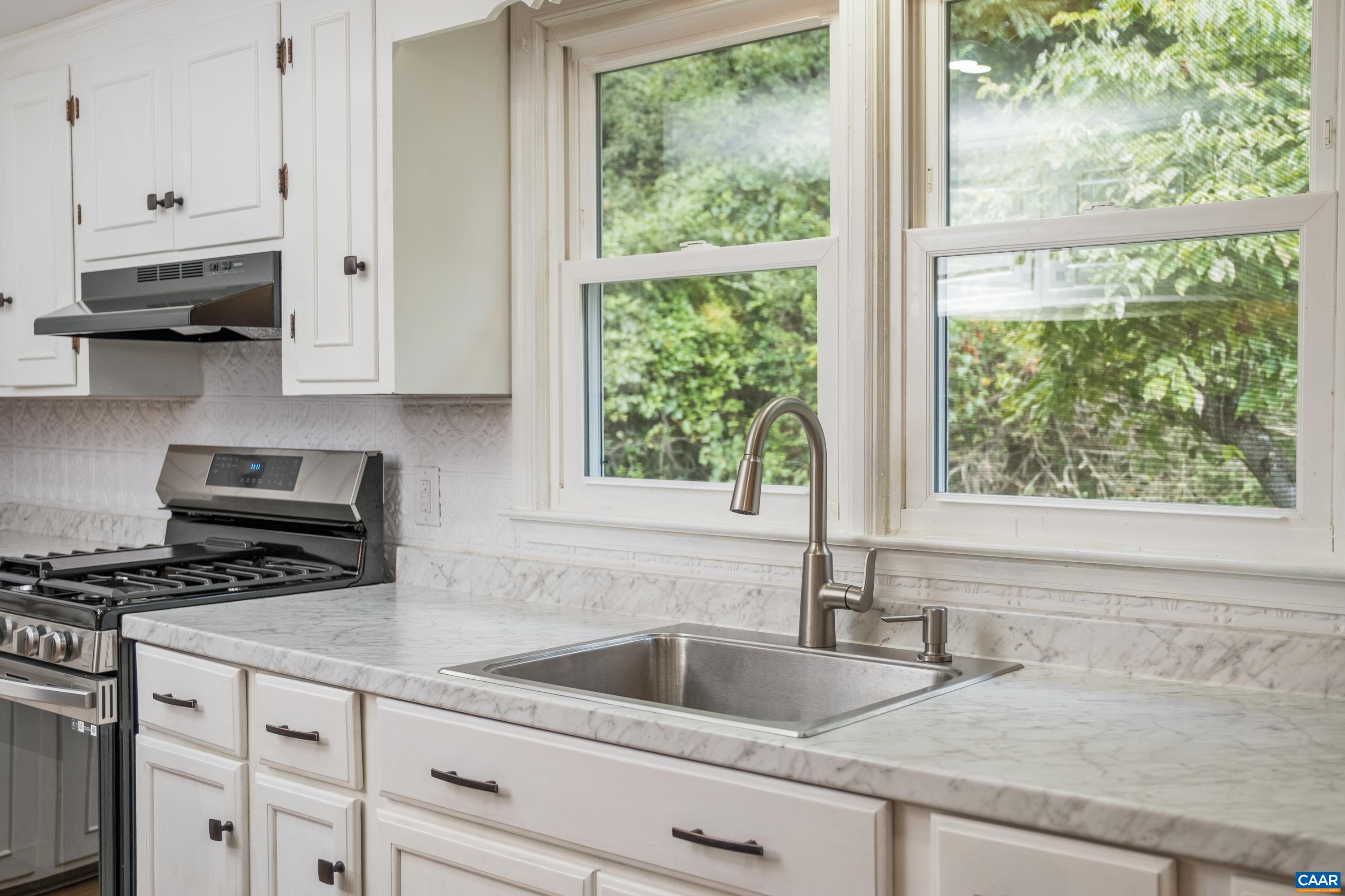 578 Maxfield Road Keswick, VA 22947 - Photo 28 of 39 a kitchen with granite countertop a sink and a window