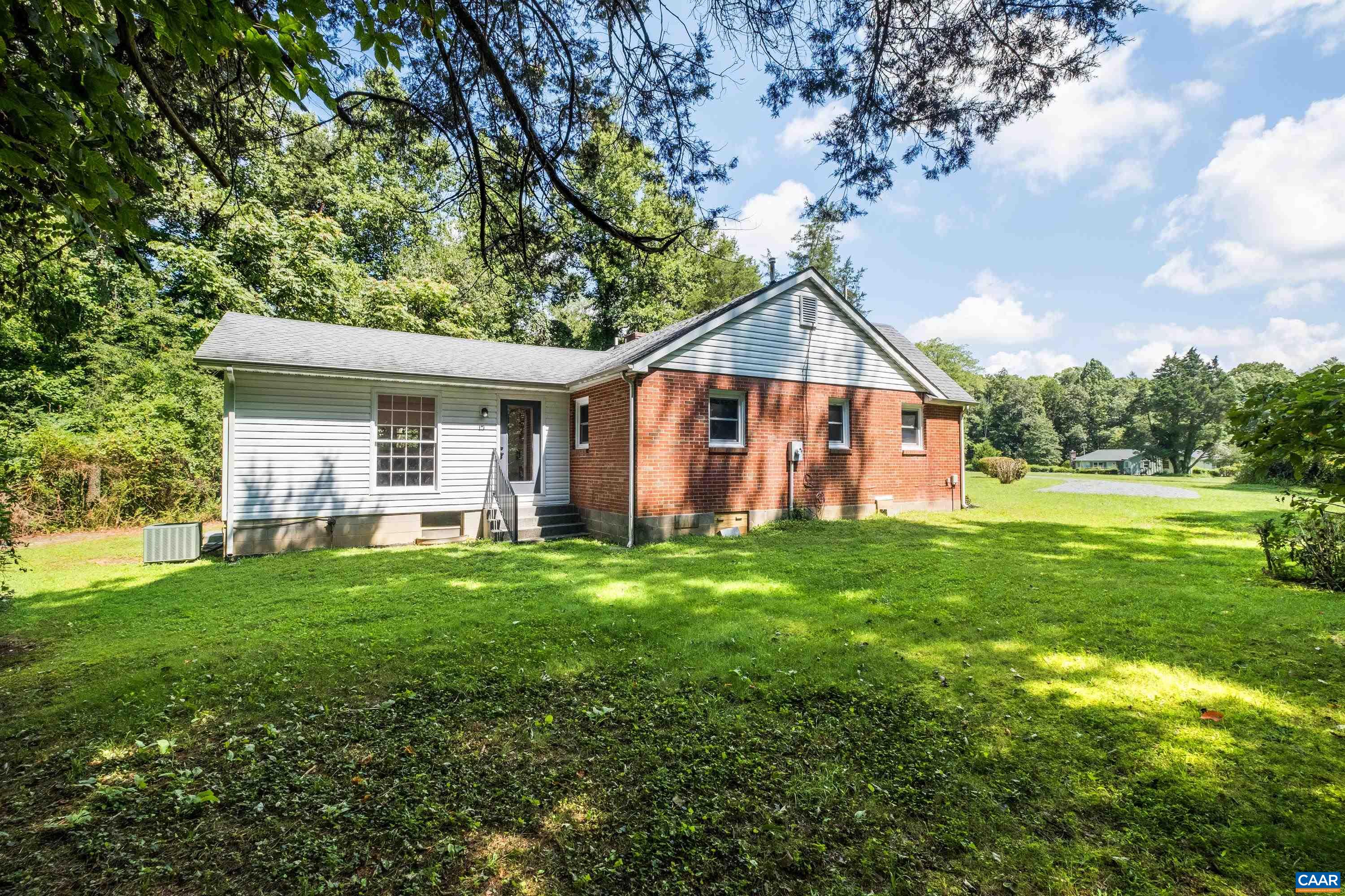 578 Maxfield Road Keswick, VA 22947 - Photo 5 of 39 a view of a house with a big yard and large trees