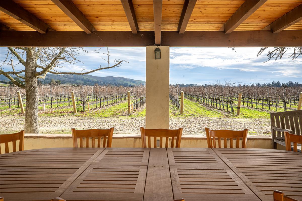 4892 Hapgood Road Lompoc, CA 93436 - Photo 25 of 32 a view of a balcony with dining table and wooden floor