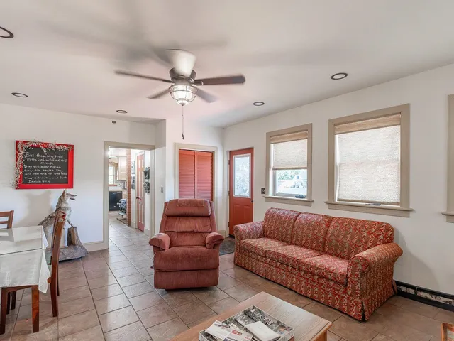 a kitchen with stainless steel appliances kitchen island granite countertop a refrigerator and a stove top oven