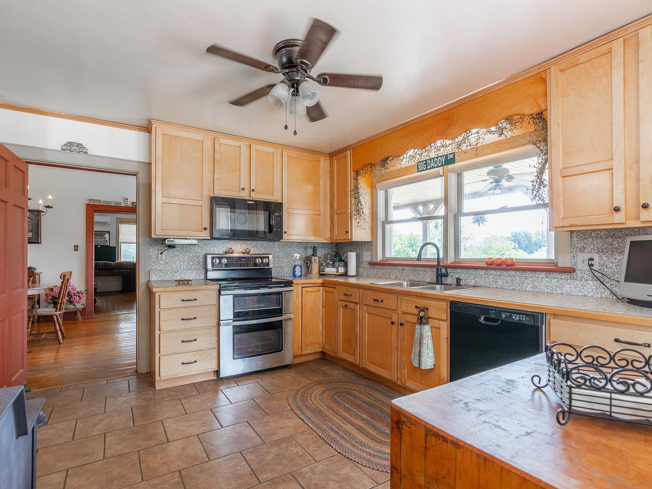 1299 North River Road Mount Crawford, VA 22841 - Photo 17 of 75 a kitchen with stainless steel appliances granite countertop a stove top oven a sink dishwasher a dining table and chairs with wooden floor
