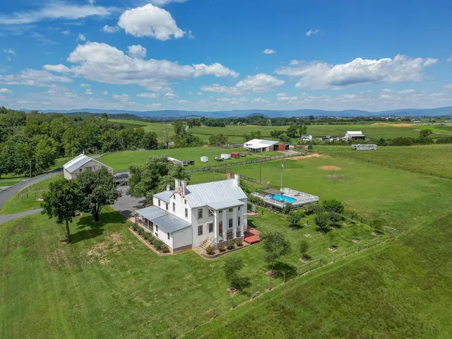an aerial view of a house with big yard