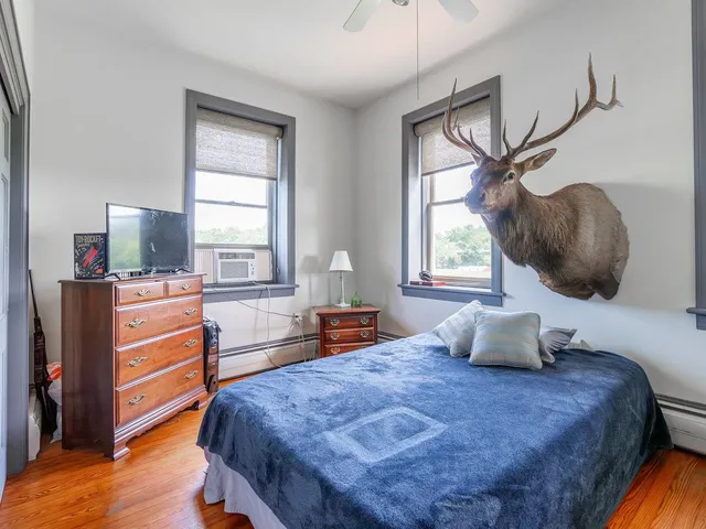 a view of a hallway with wooden floor windows and livingroom