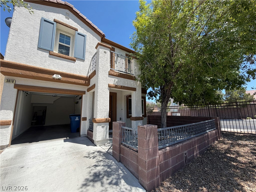 3610 Wireless Court Las Vegas, NV 89129 - Photo 13 of 15 A well-maintained facade with a prominent attached garage and inviting balcony space.