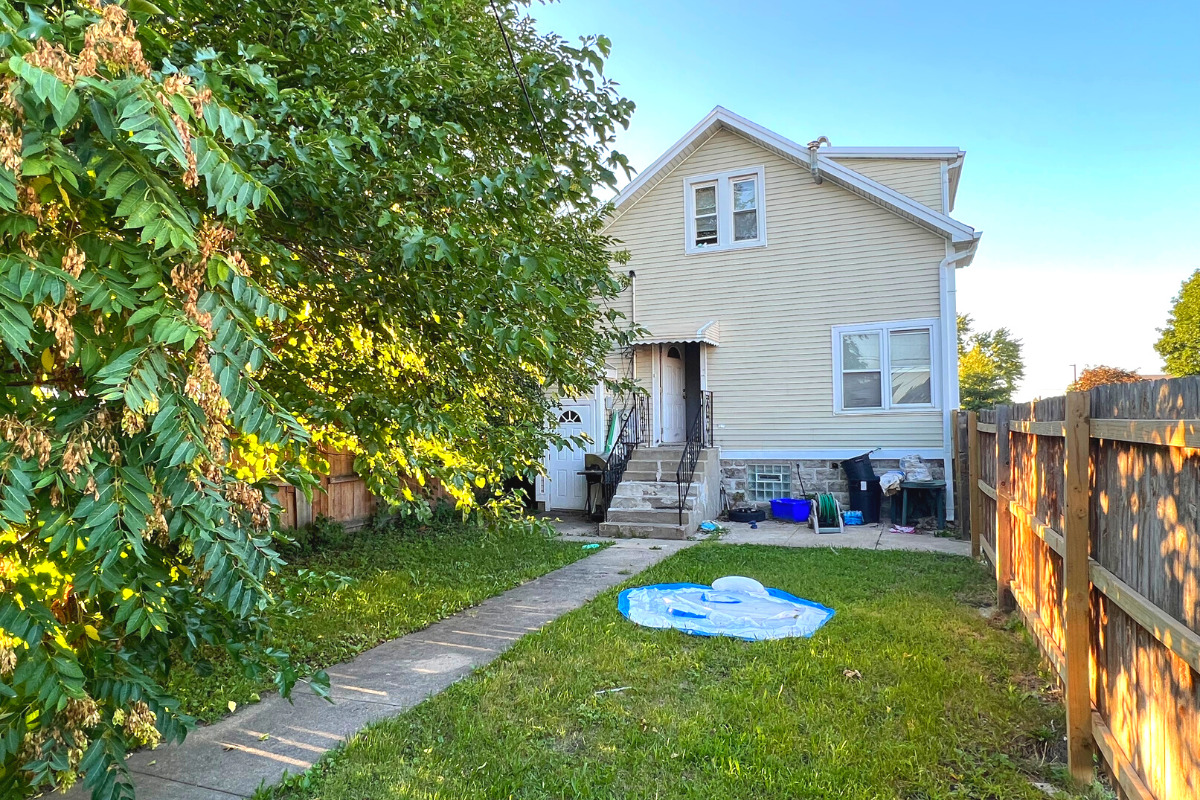7501 West 58th Street Summit, IL 60501 - Photo 8 of 8 a view of a house with a yard and garden