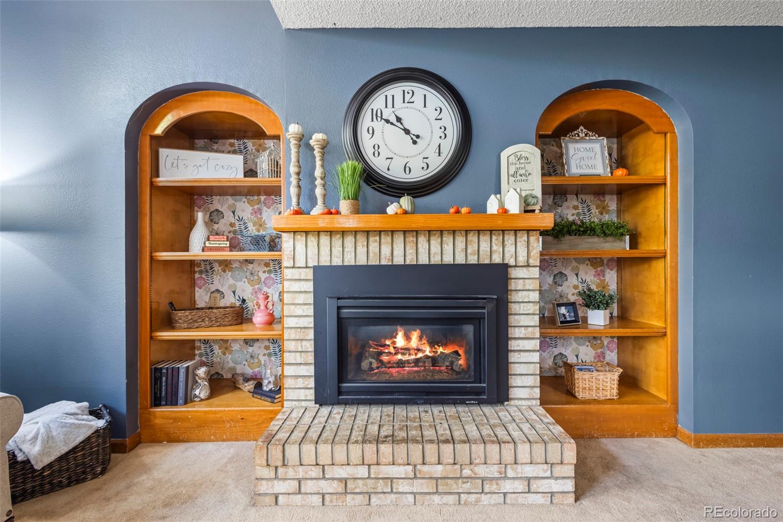 17538 East Baker Place Aurora, CO 80013 - Photo 20 of 50 a wooden floor with a fireplace and a clock on it
