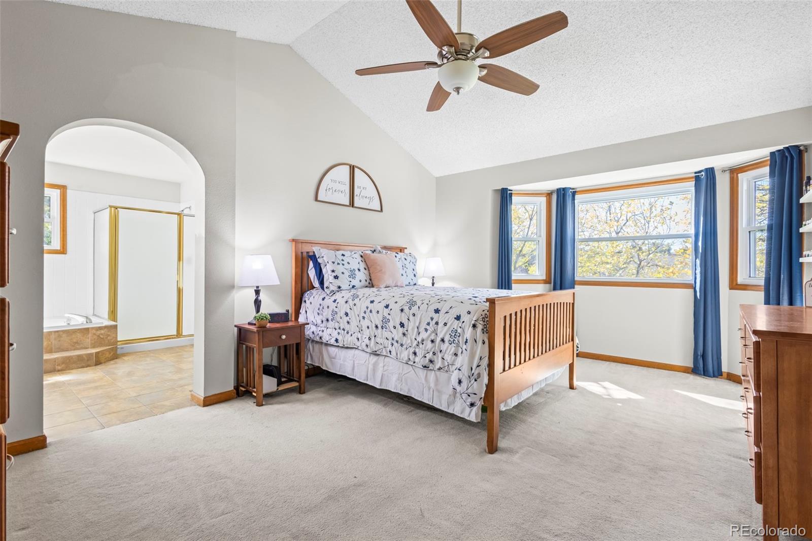 17538 East Baker Place Aurora, CO 80013 - Photo 22 of 50 a bedroom with a bed a large window and a chandelier