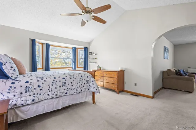 a bedroom with a bed dresser and a window