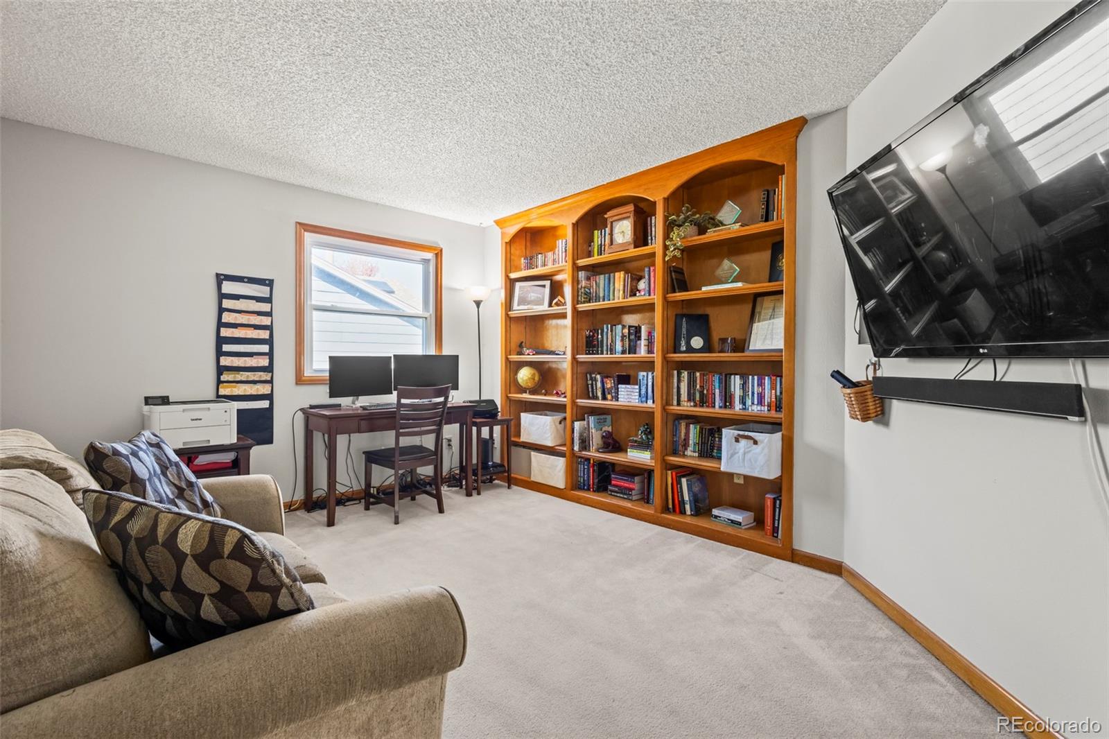 17538 East Baker Place Aurora, CO 80013 - Photo 25 of 50 a living room with furniture and a flat screen tv