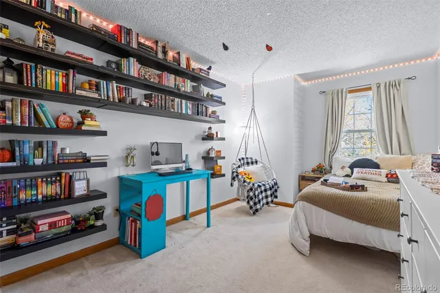 a bedroom with bed and a book shelf
