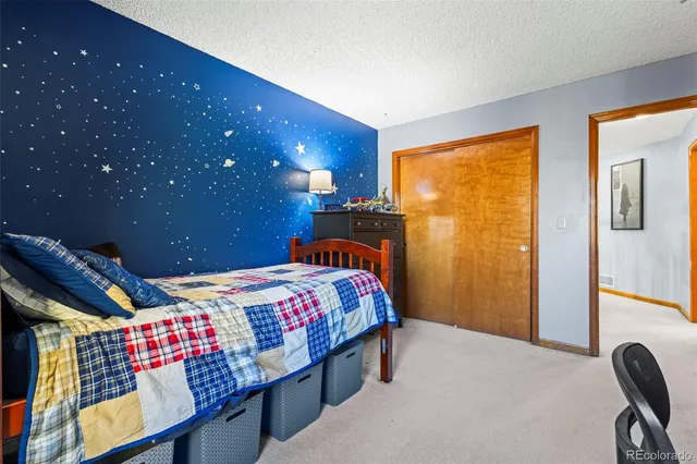 a bedroom with a bed and a dresser