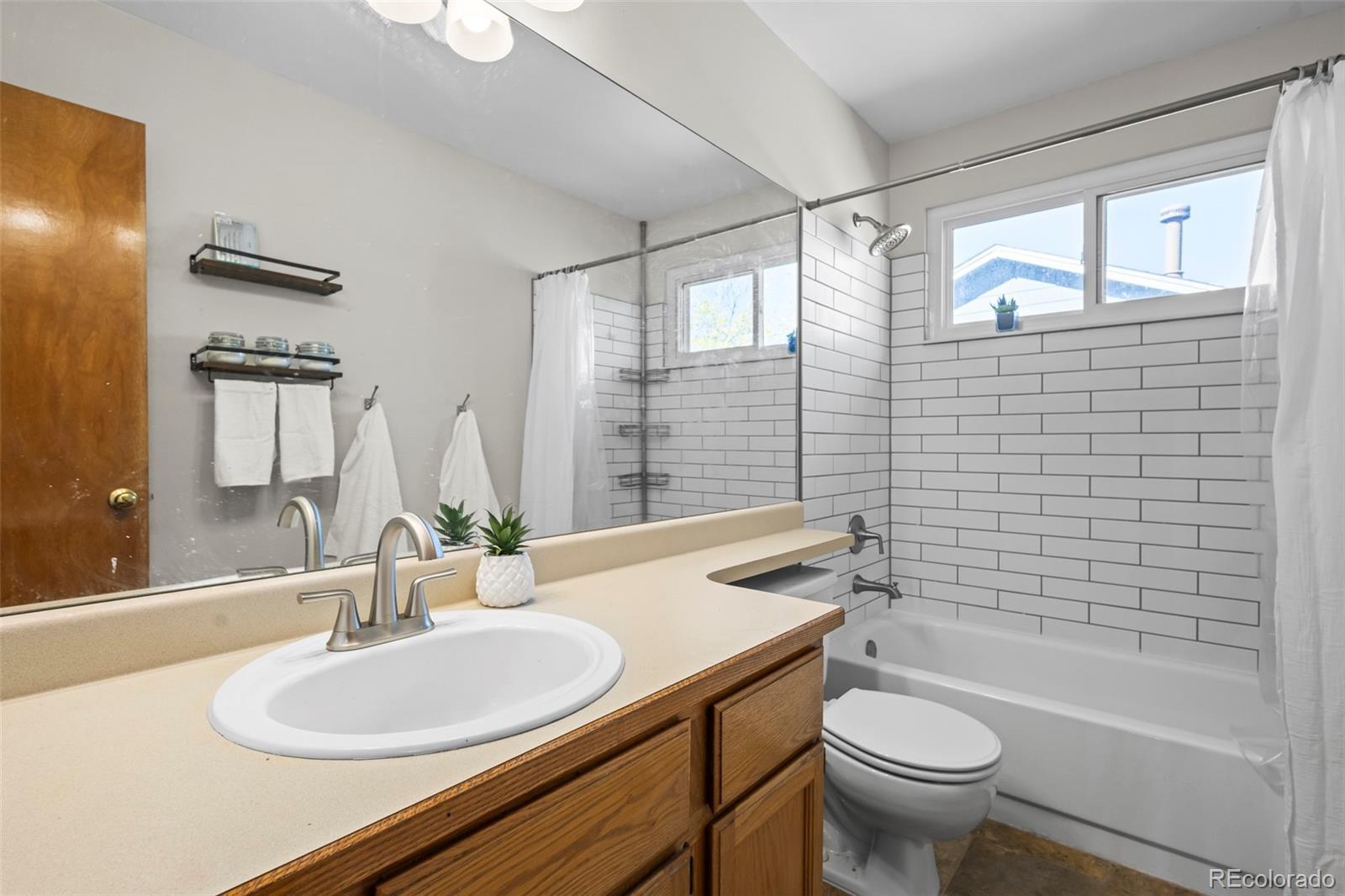 17538 East Baker Place Aurora, CO 80013 - Photo 32 of 50 a bathroom with a sink toilet and shower