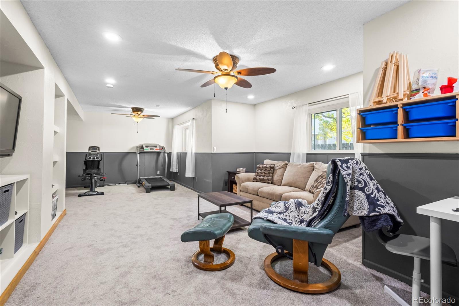 17538 East Baker Place Aurora, CO 80013 - Photo 34 of 50 a living room with furniture a flat screen tv and kitchen view