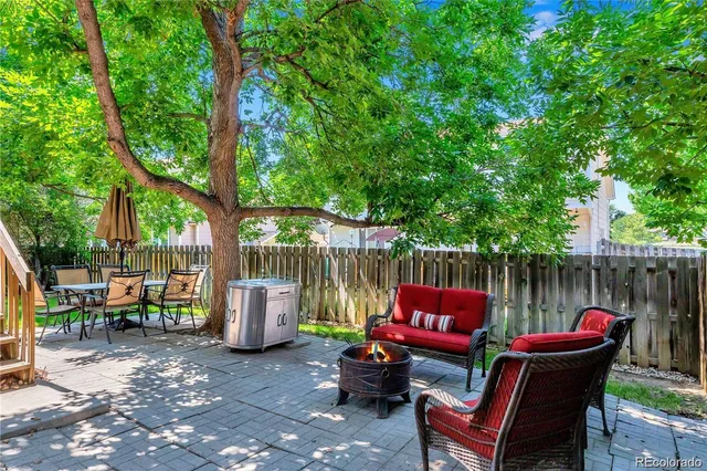 a outdoor view with a sitting space and large trees
