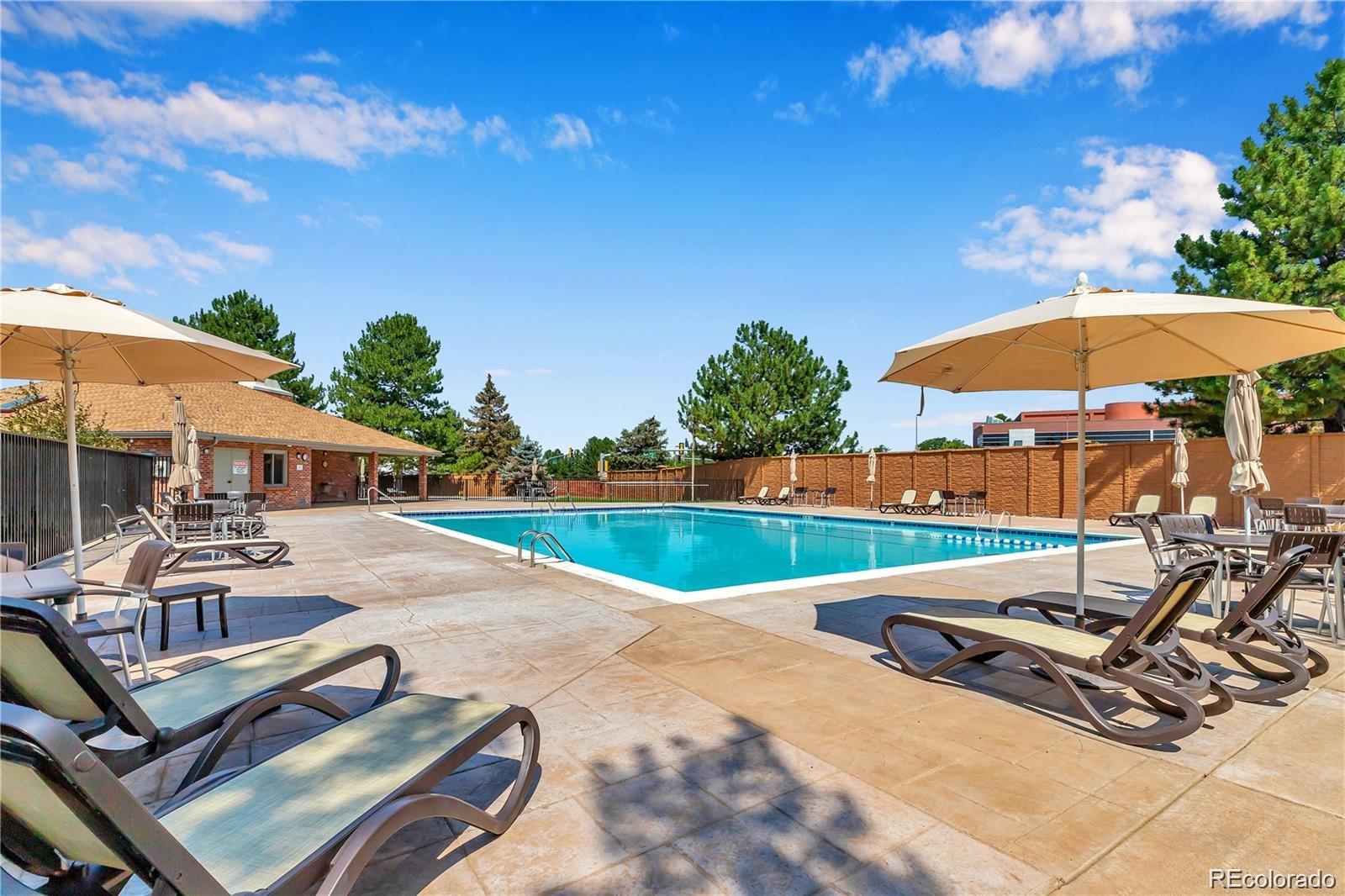 17538 East Baker Place Aurora, CO 80013 - Photo 47 of 50 a view of a patio with a table and chairs under an umbrella