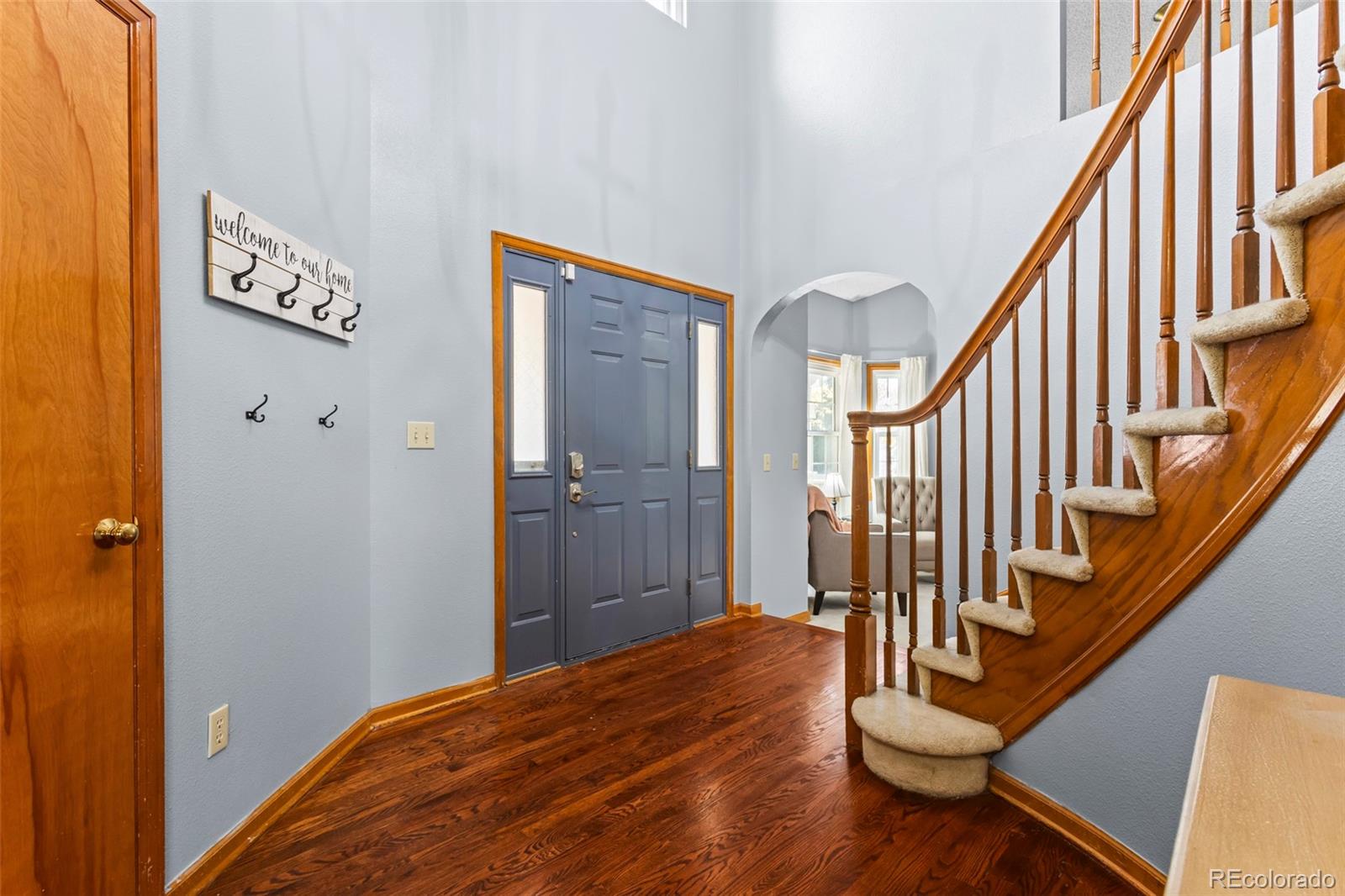 17538 East Baker Place Aurora, CO 80013 - Photo 6 of 50 a view of a hallway with wooden floor and staircase