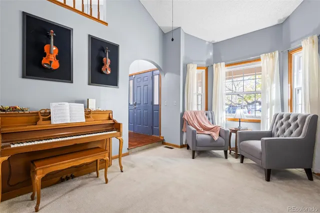 a living room with furniture a flat screen tv and a window