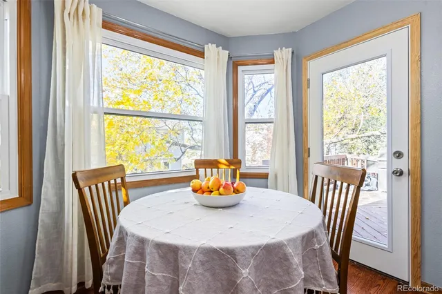 a dining room with furniture a table and chairs