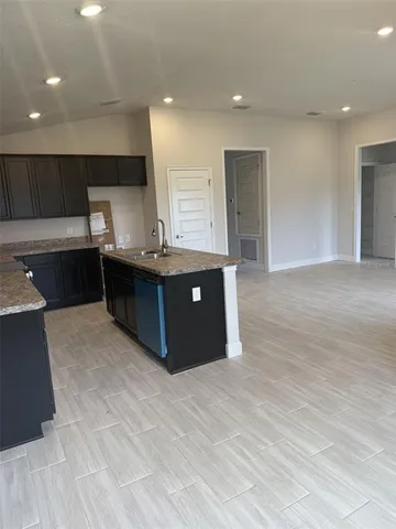 a kitchen with stainless steel appliances granite countertop a stove and a sink