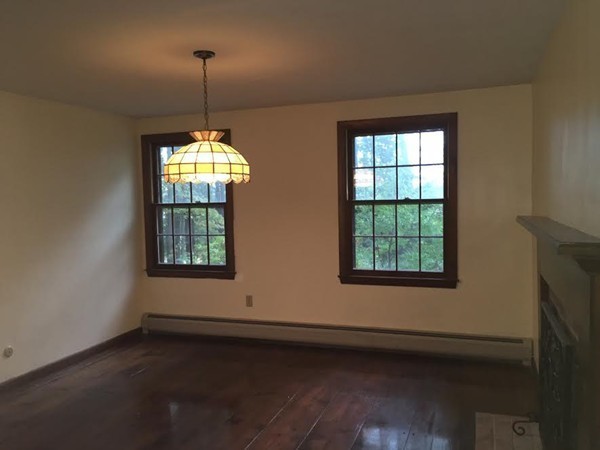 76 Proctor Road Townsend, MA 01469 - Photo 6 of 30 a view of an empty room with wooden floor and a window