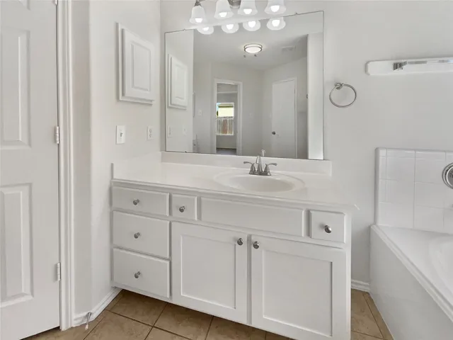 a bathroom with a sink vanity and mirror