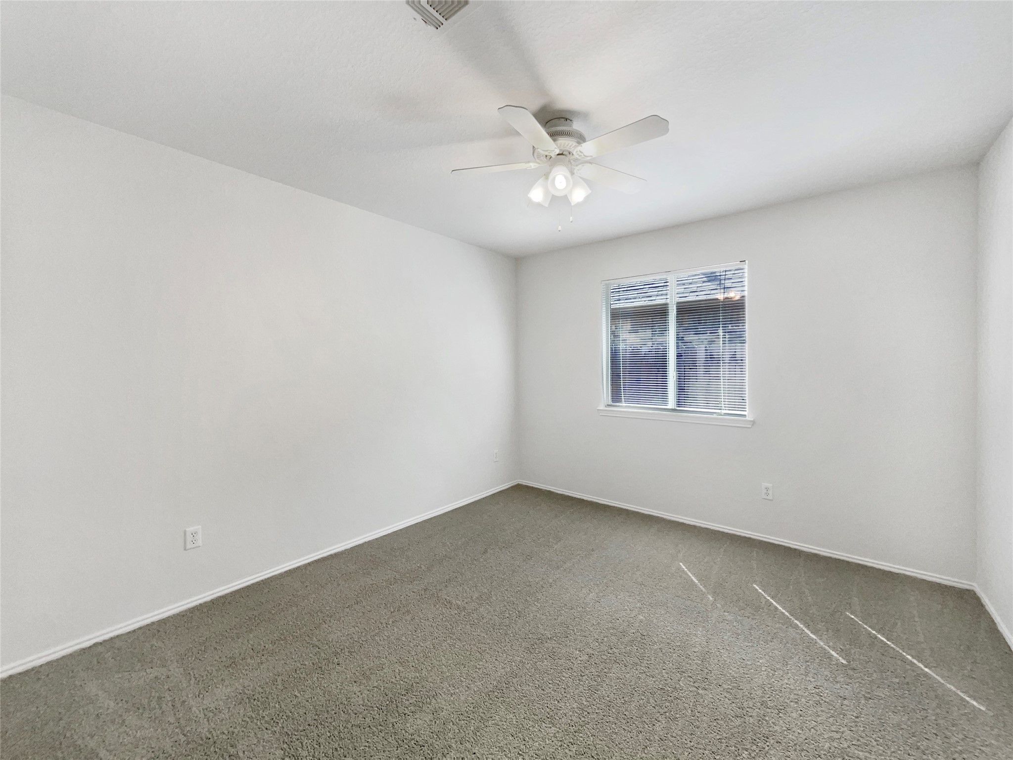 18810 Appletree Ridge Road Houston, TX 77084 - Photo 18 of 24 an empty room with a window and a fan