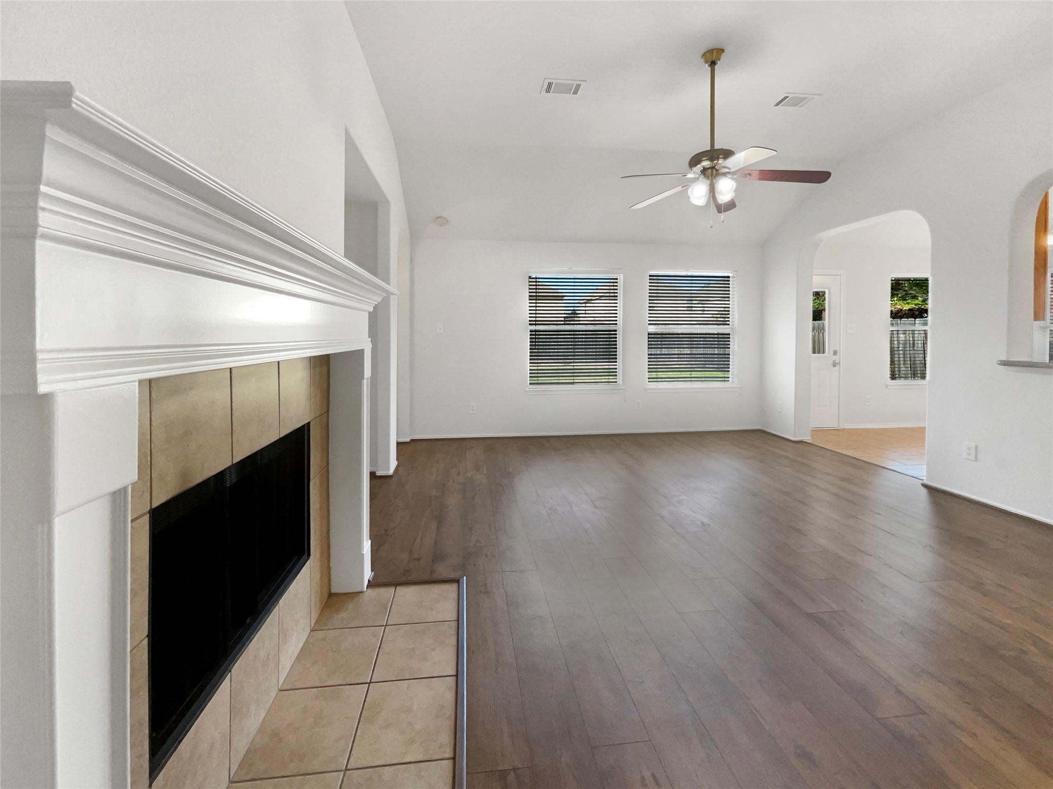 18810 Appletree Ridge Road Houston, TX 77084 - Photo 23 of 24 a view of an empty room with wooden floor fireplace and a window