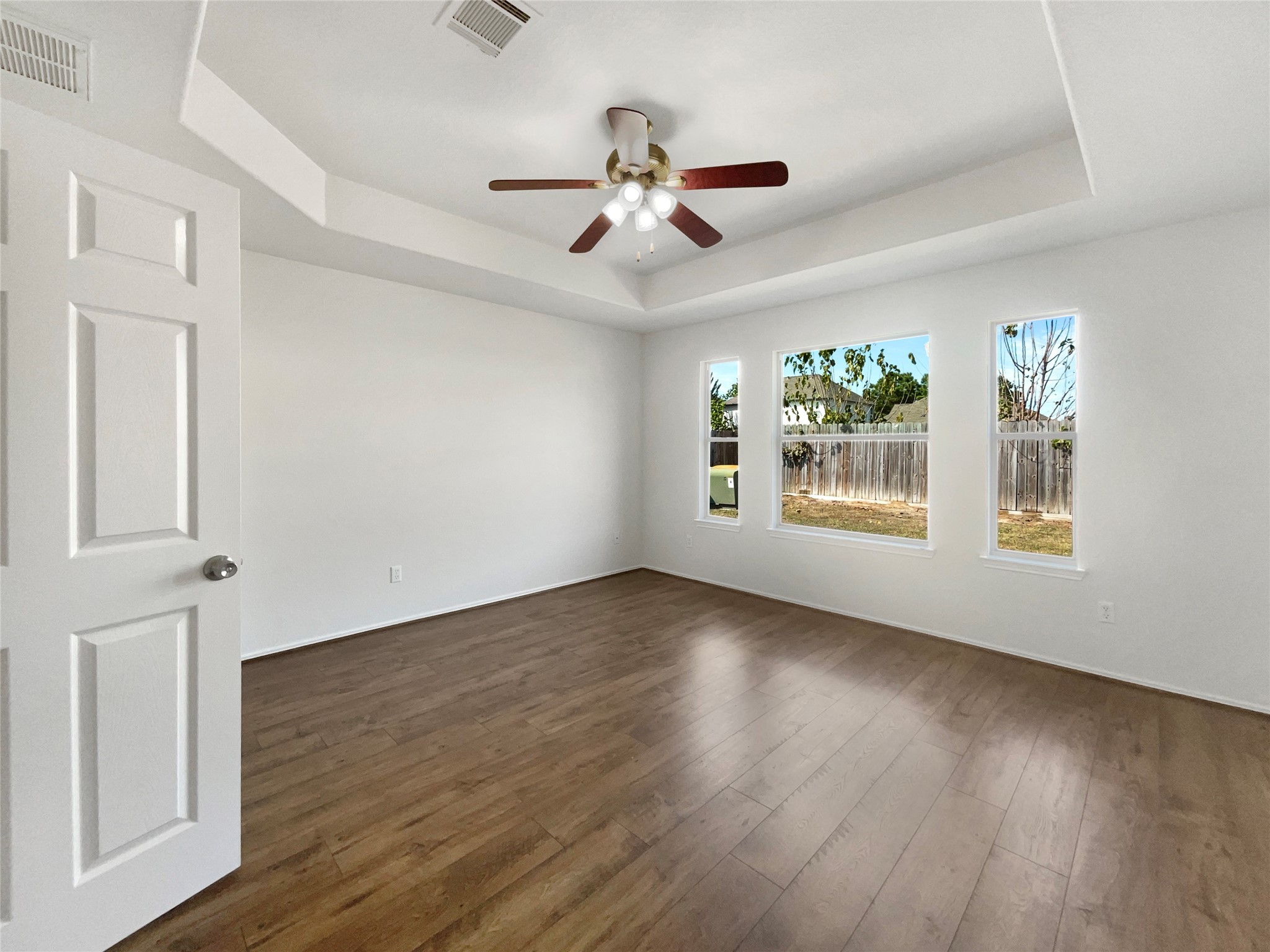 18810 Appletree Ridge Road Houston, TX 77084 - Photo 5 of 24 a view of an empty room with wooden floor and a window