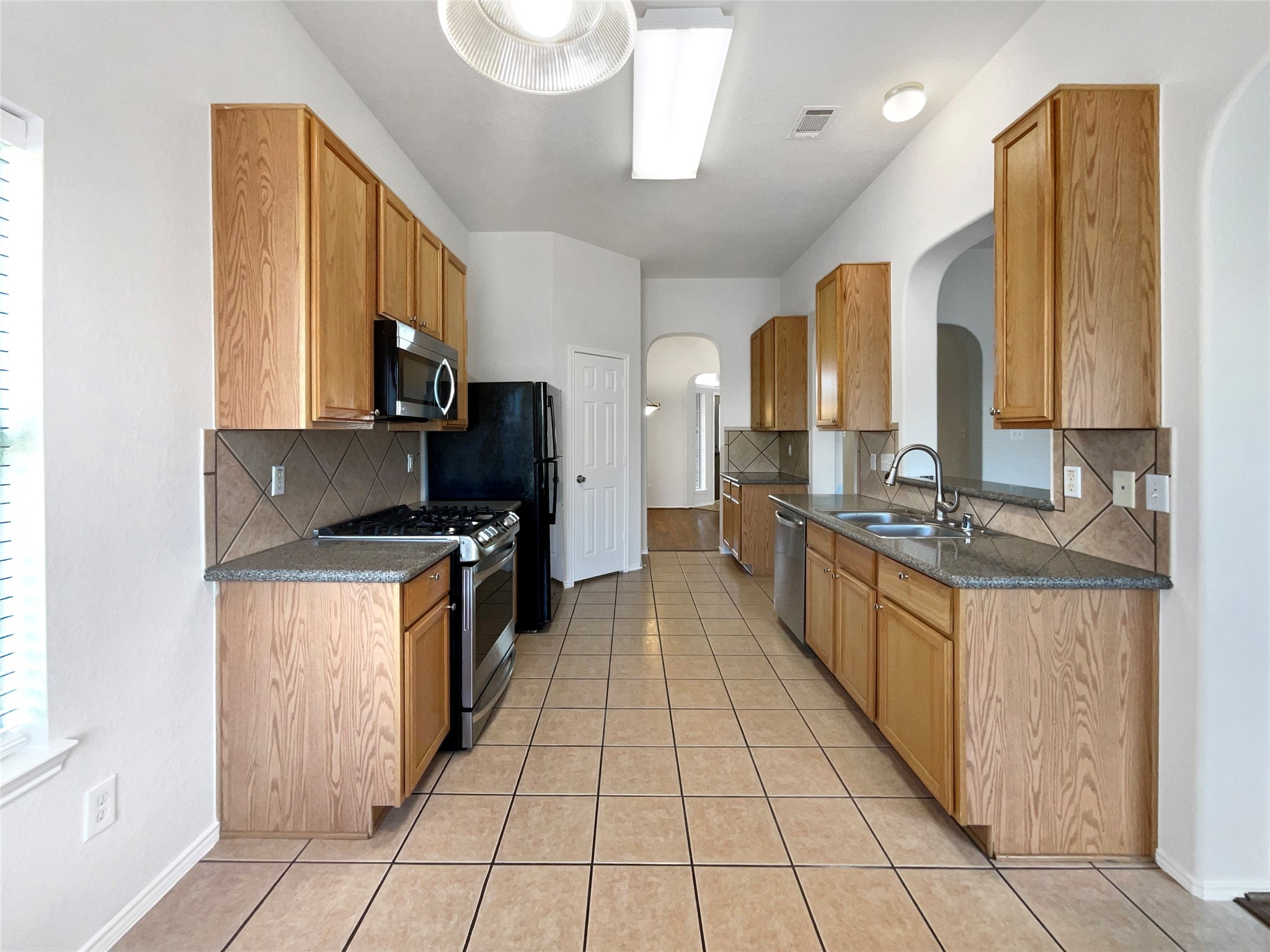 18810 Appletree Ridge Road Houston, TX 77084 - Photo 6 of 24 a large kitchen with stainless steel appliances granite countertop a large counter top a stove and a refrigerator