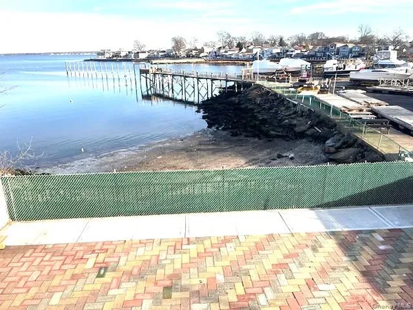 a view of a balcony with city and ocean view