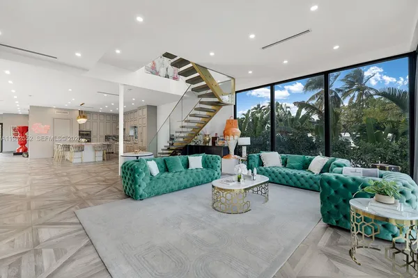 a living room with furniture and a large window