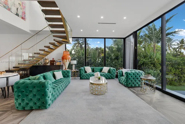 a living room with furniture and a floor to ceiling window