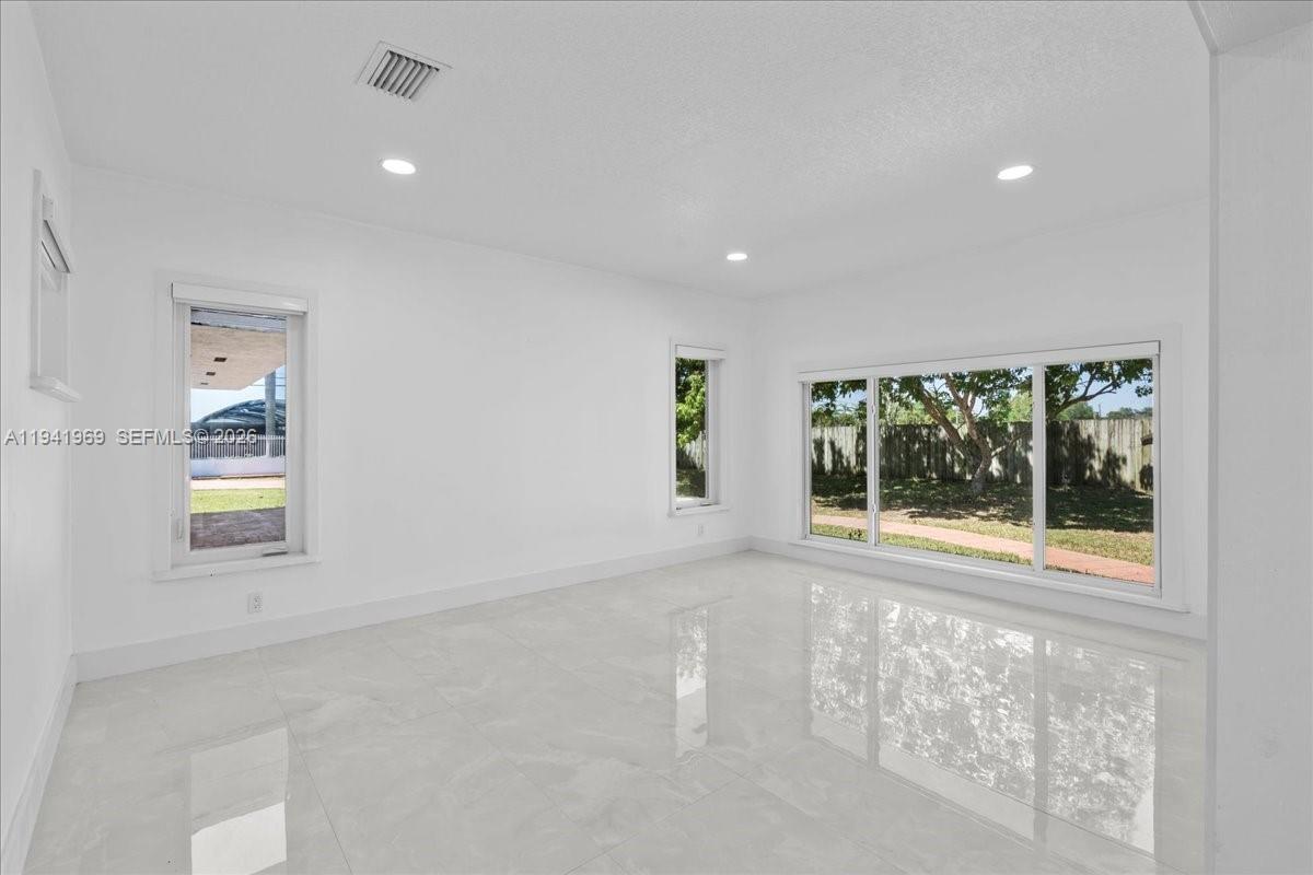 24555 Southwest 167th Avenue, Unit 1 Homestead, FL 33031 - Photo 13 of 33 an empty room with windows