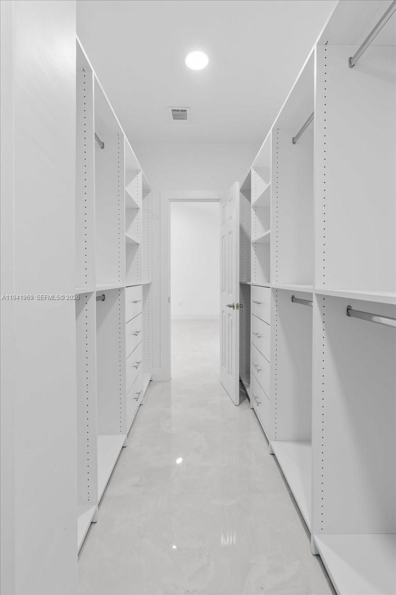 24555 Southwest 167th Avenue, Unit 1 Homestead, FL 33031 - Photo 19 of 33 a view of walk in closet with white walls