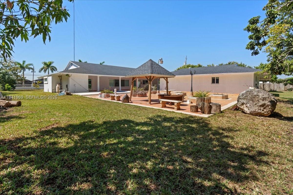 24555 Southwest 167th Avenue, Unit 1 Homestead, FL 33031 - Photo 24 of 33 a view of a house with a yard and sitting area
