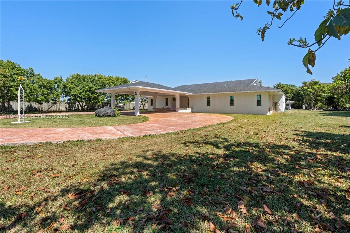 24555 Southwest 167th Avenue, Unit 1 Homestead, FL 33031 - Photo 26 of 33 a view of big yard with a house