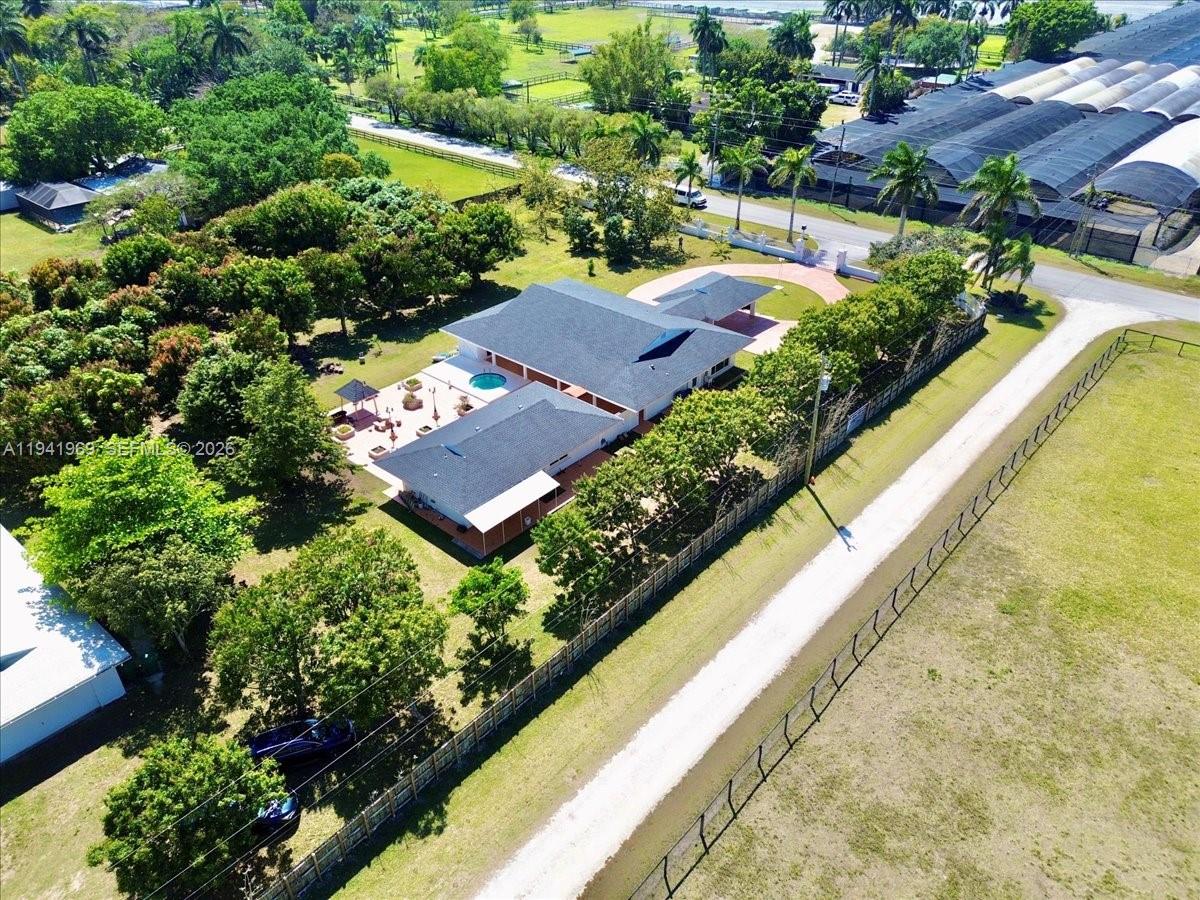 24555 Southwest 167th Avenue, Unit 1 Homestead, FL 33031 - Photo 29 of 33 an aerial view of a house with a garden and lake view