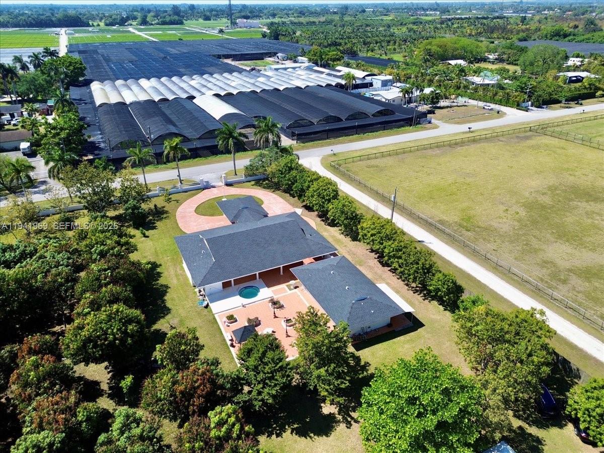 24555 Southwest 167th Avenue, Unit 1 Homestead, FL 33031 - Photo 30 of 33 an aerial view of a house with a swimming pool yard and outdoor seating