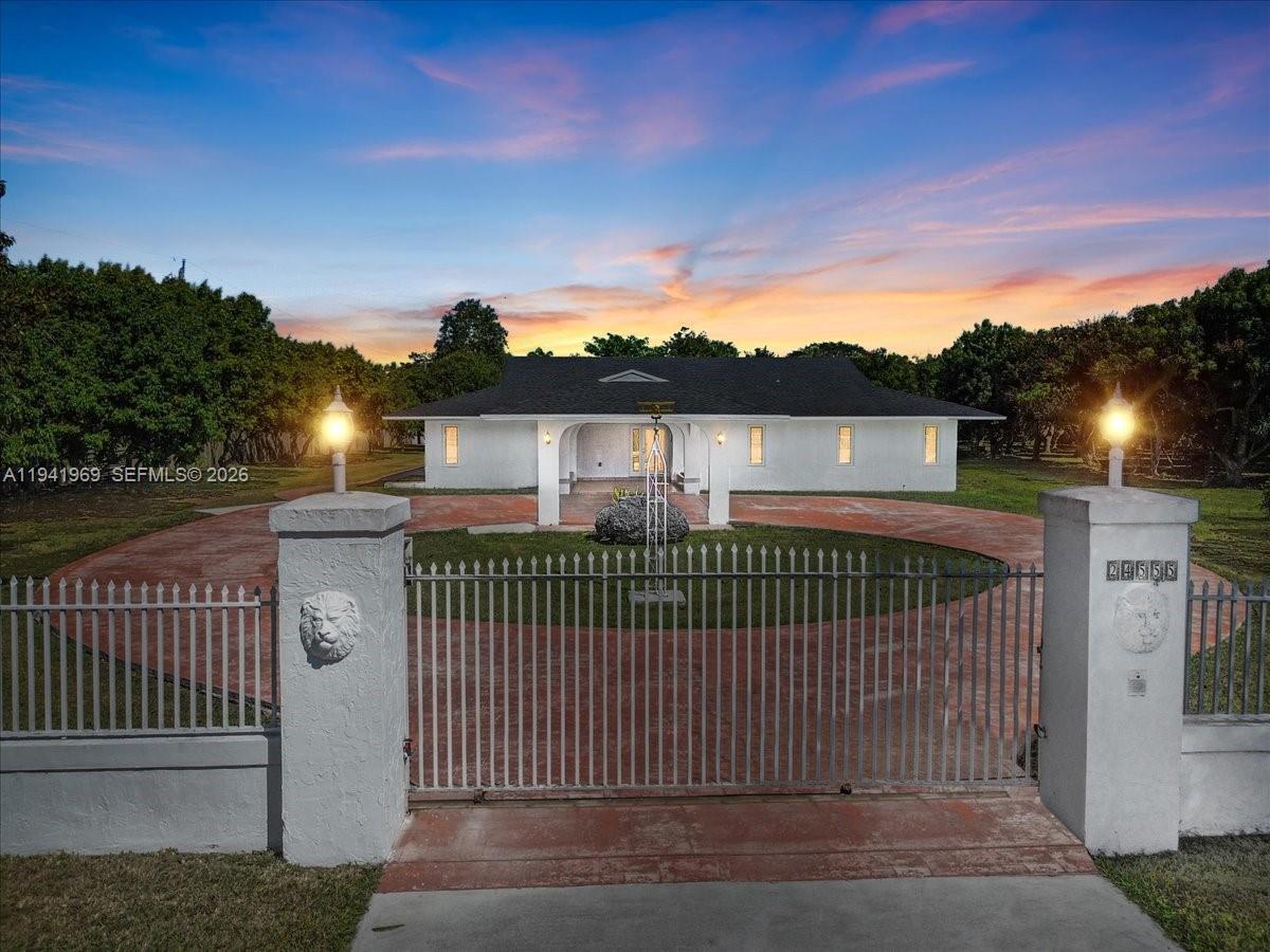 24555 Southwest 167th Avenue, Unit 1 Homestead, FL 33031 - Photo 32 of 33 a view of a brick house with a street view