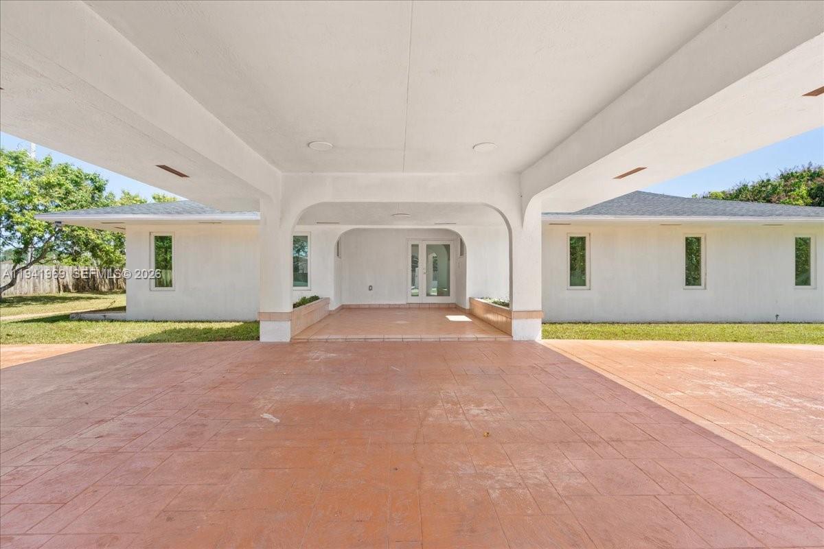 24555 Southwest 167th Avenue, Unit 1 Homestead, FL 33031 - Photo 9 of 33 a view of a house with a swimming pool and a porch