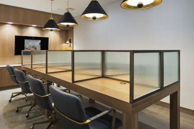 a room with pool table and windows