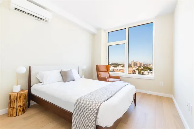 a bedroom with a bed and a window